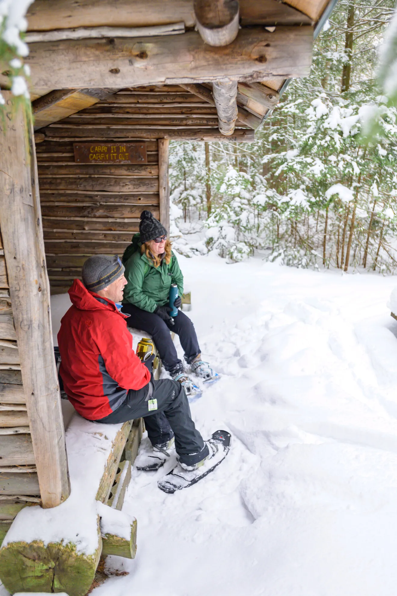 Snowshoers sitting in a lean-to.