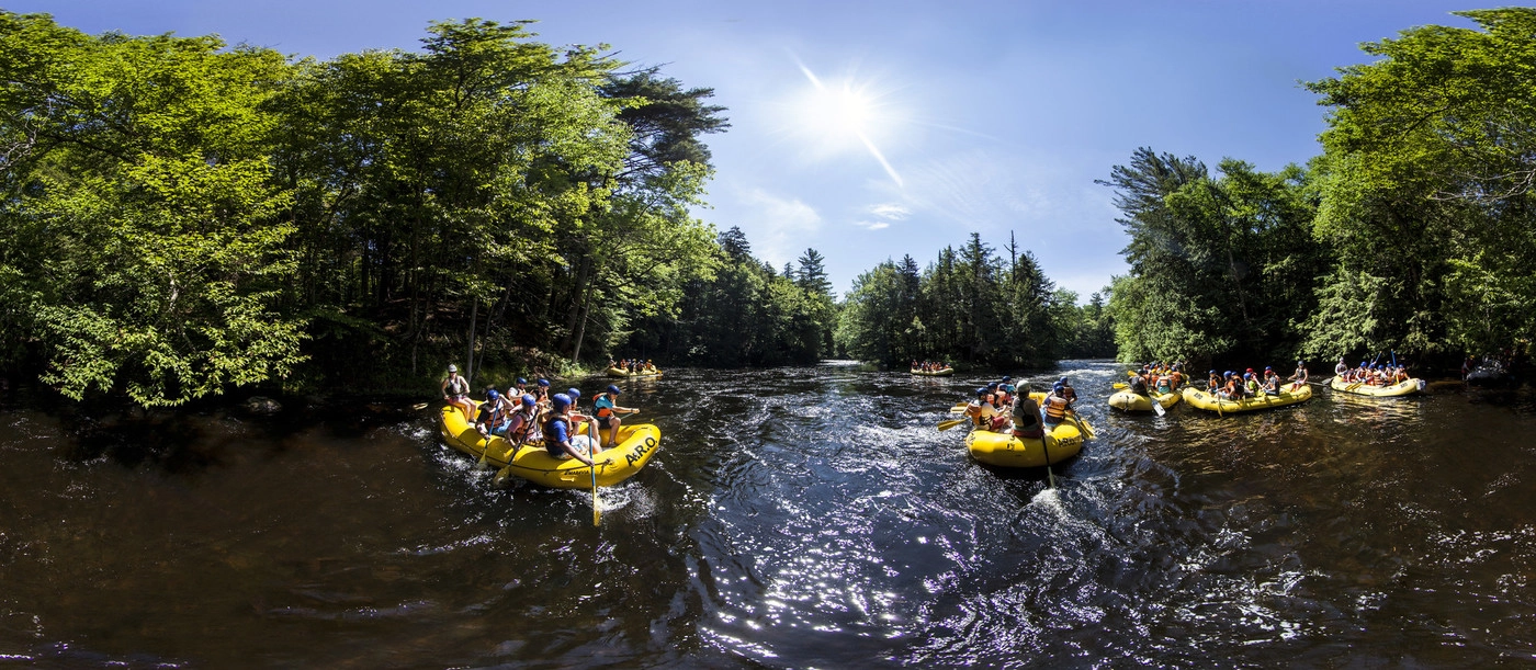 A group of people whitewater rafting in Saranac Lake.