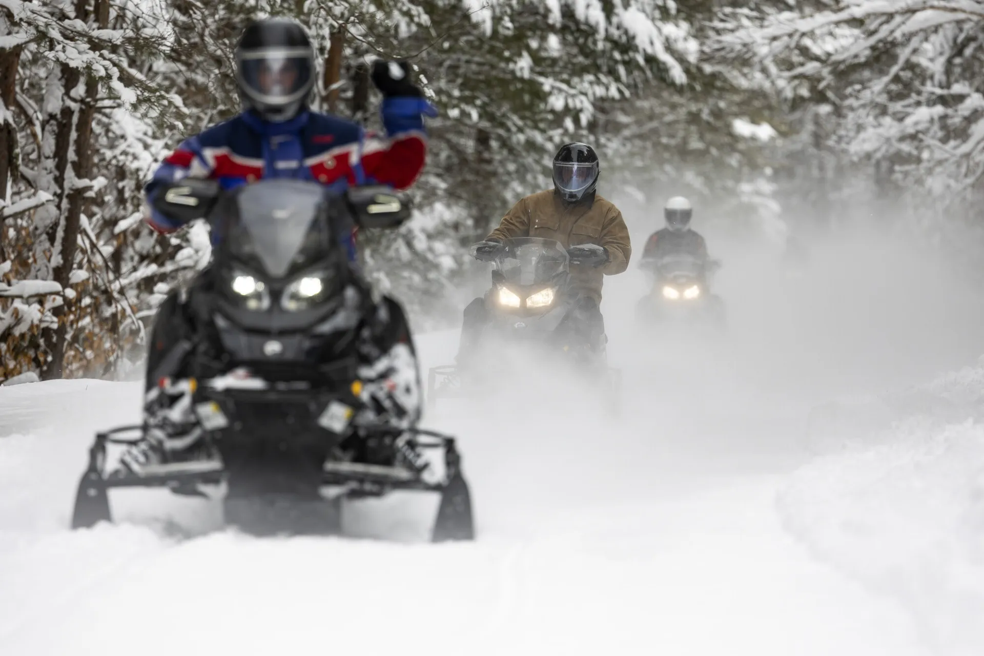 People snowmobiling
