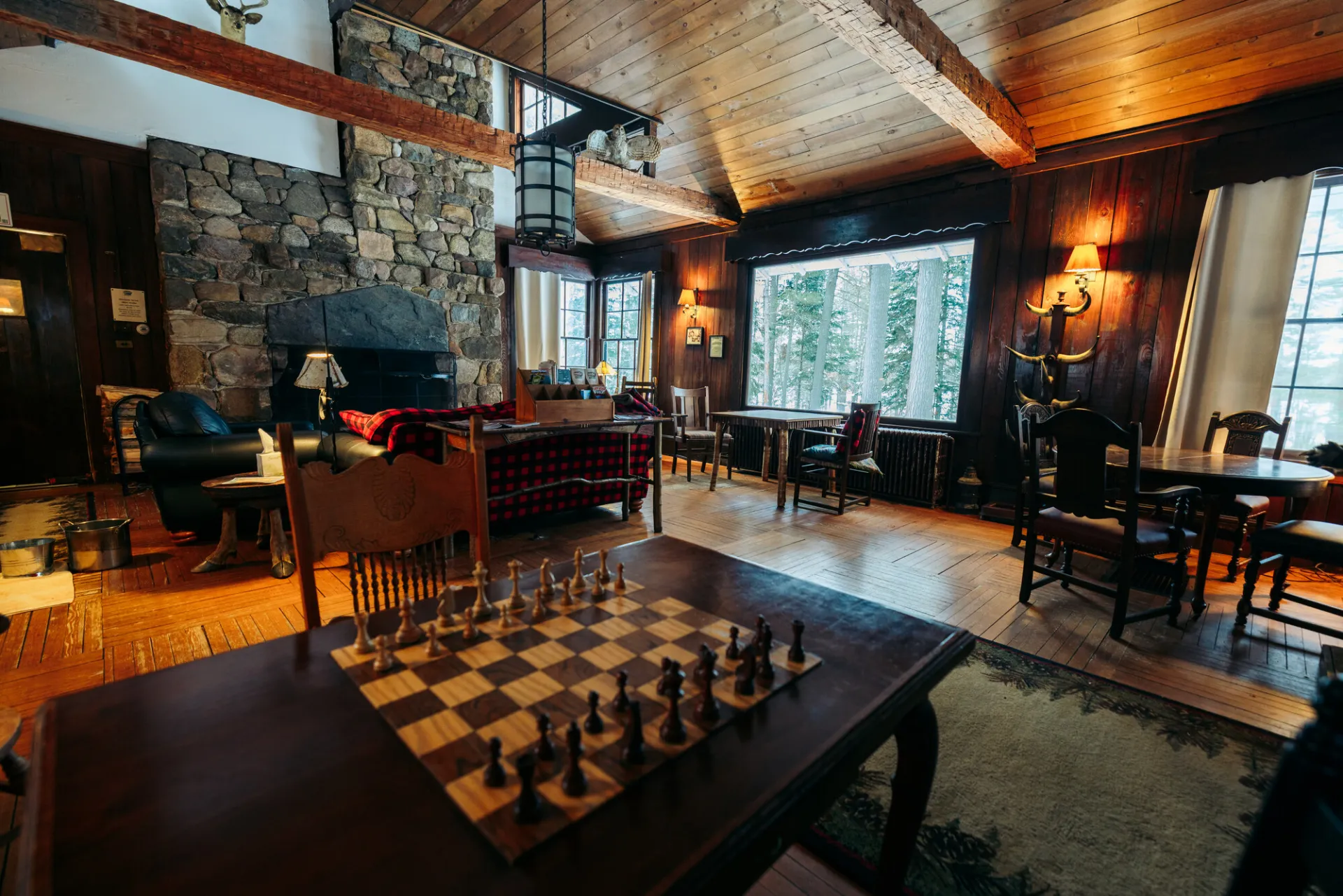 A grand lodge bedroom with a chess board and wood finishings.