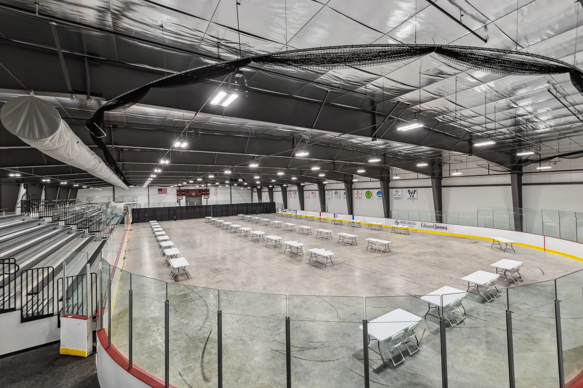 The de-iced rink at the Saranac Lake Civic Center set up with tables for an expo.