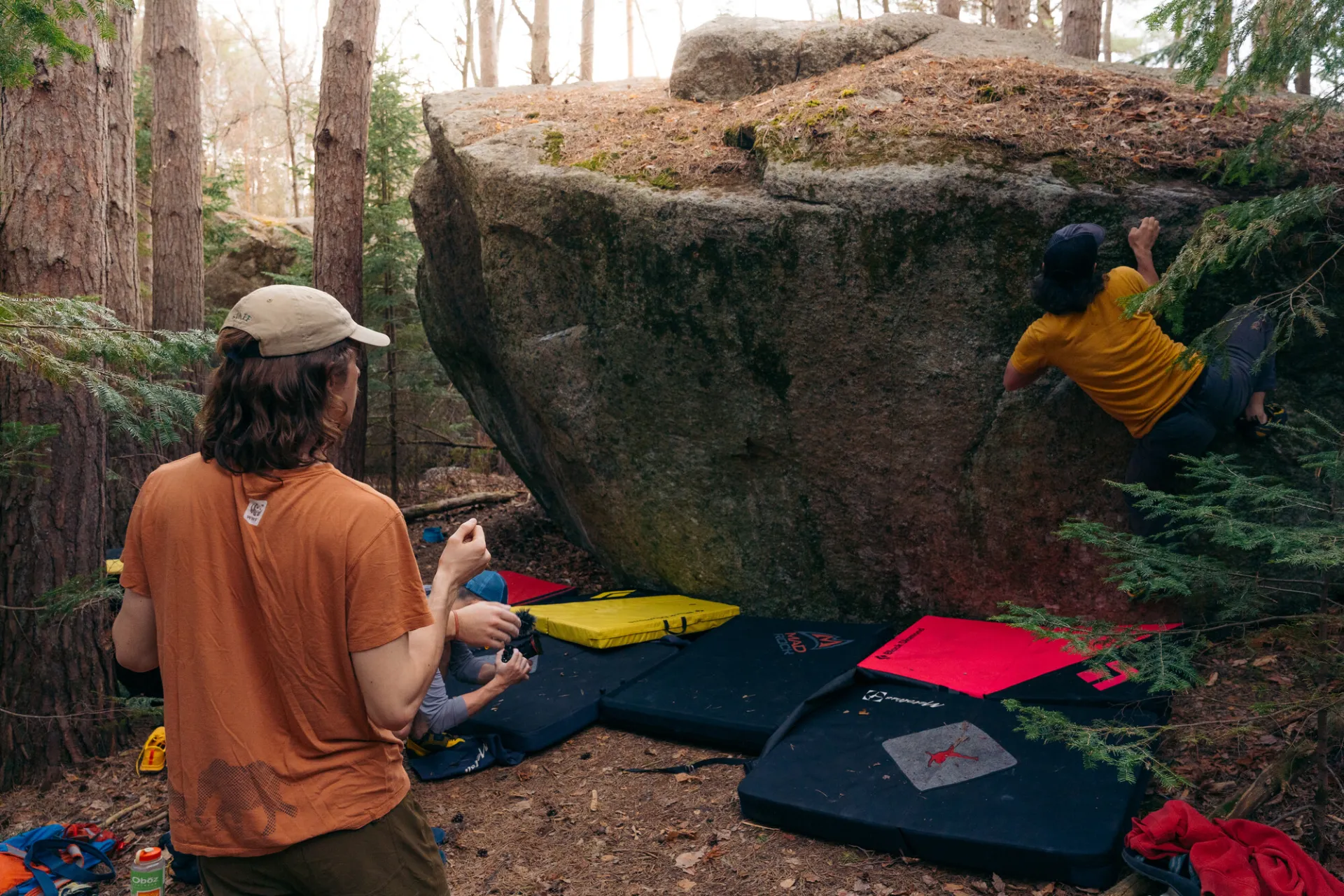 A climber boulders across a slanting rock face