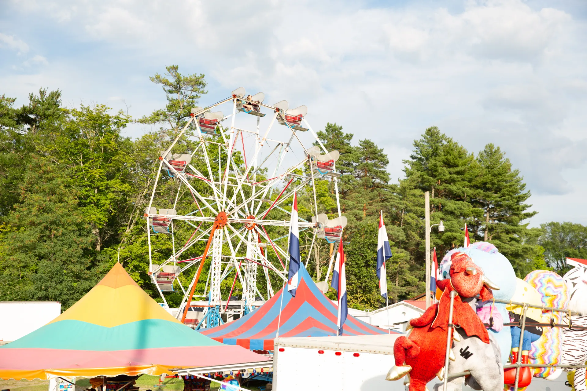 A ferris wheel above colorful tents