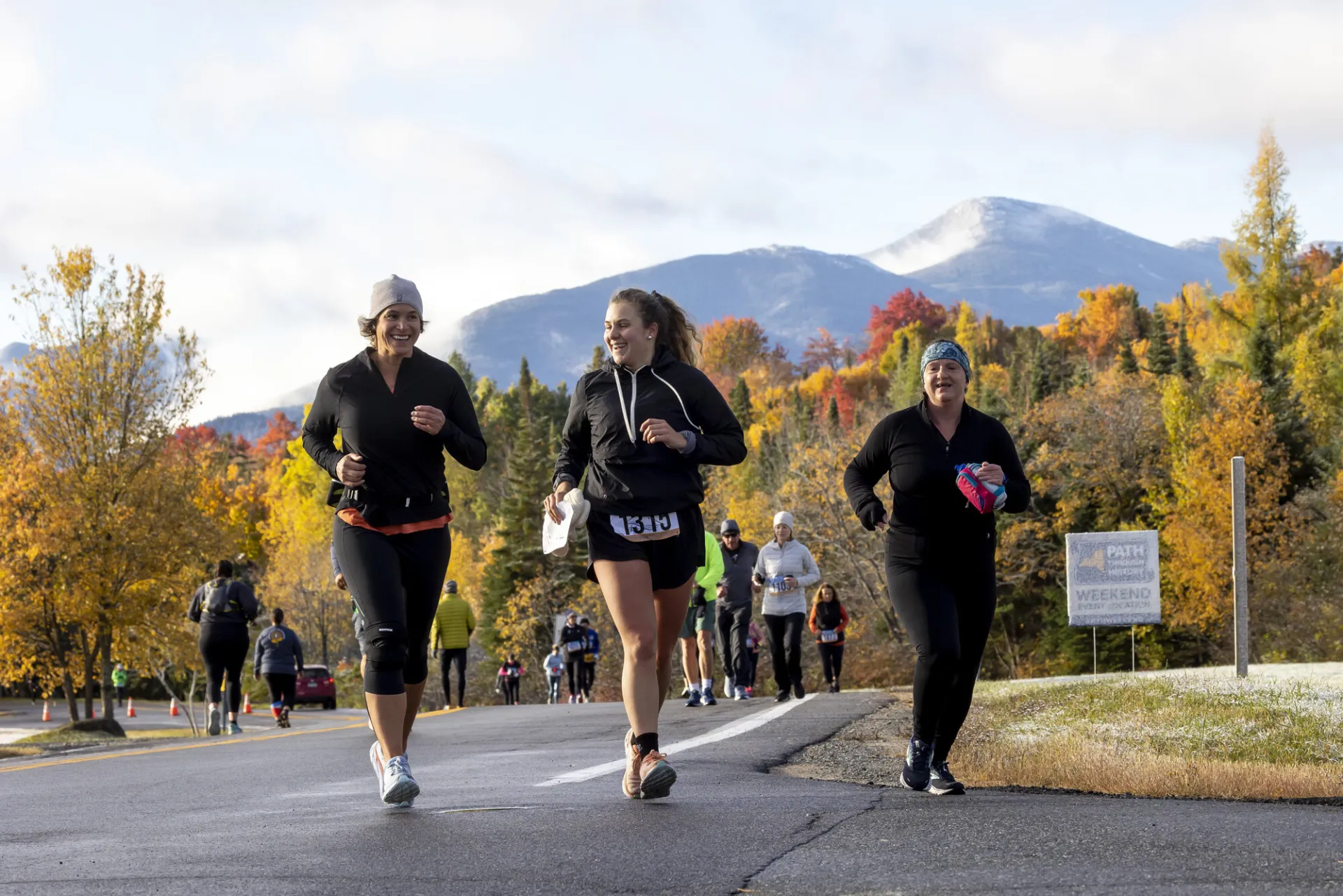Trio of runners during race with mountains in background