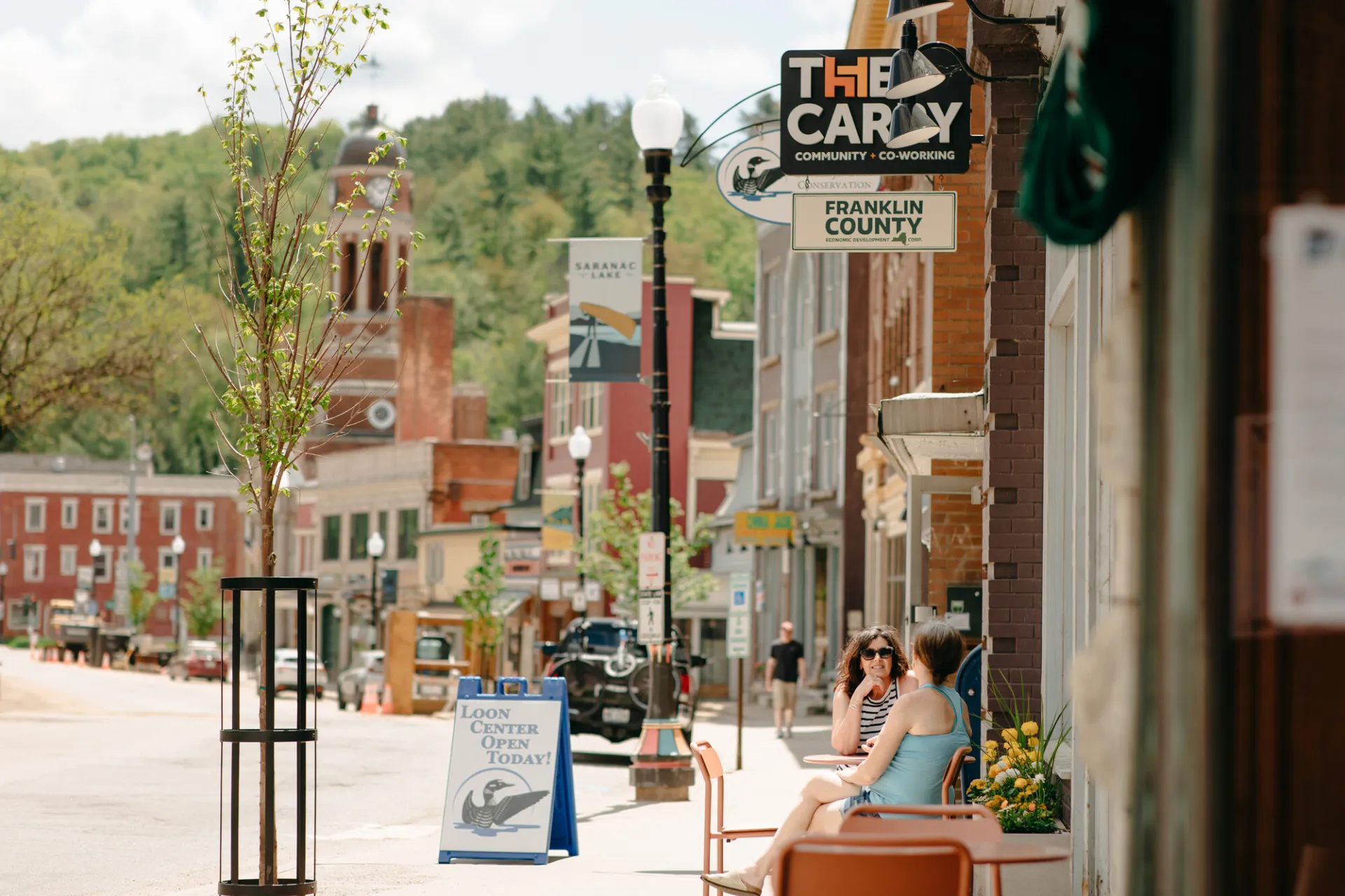 People walk on the main street of a small town. 