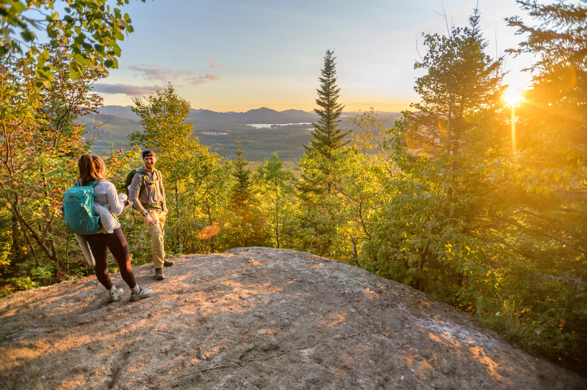 Two people in the last light on a mountain