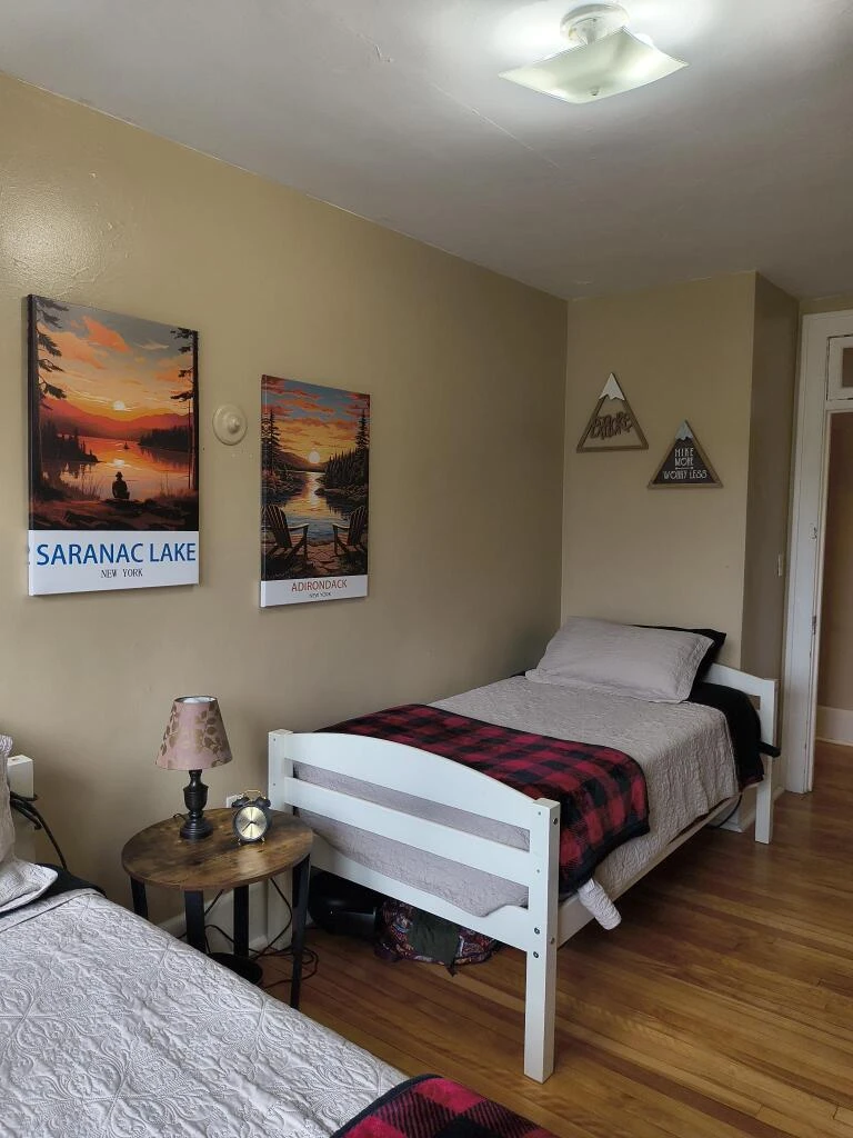 A cozy room with two twin sized beds.
