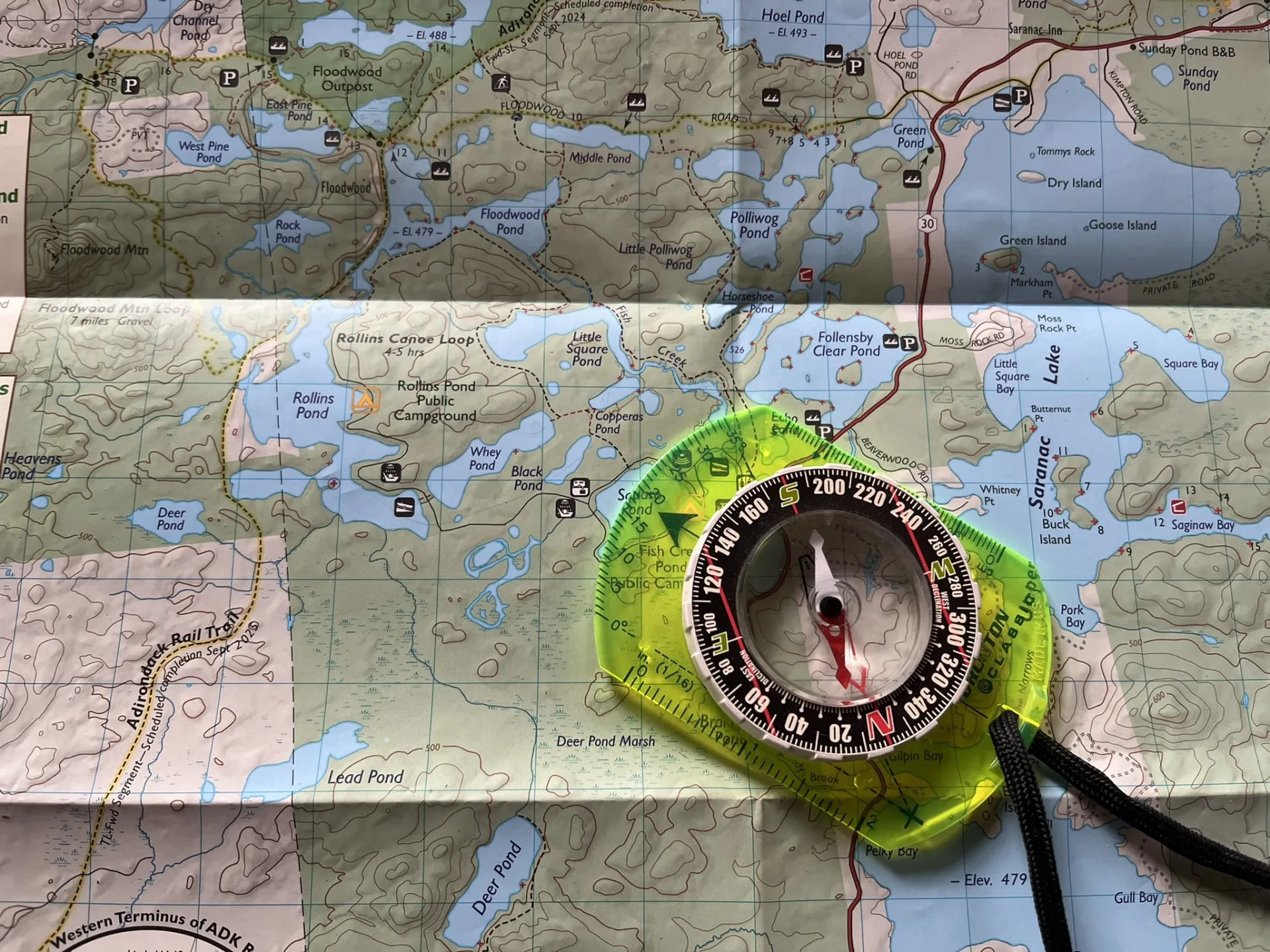 A map with a compass laying on top.