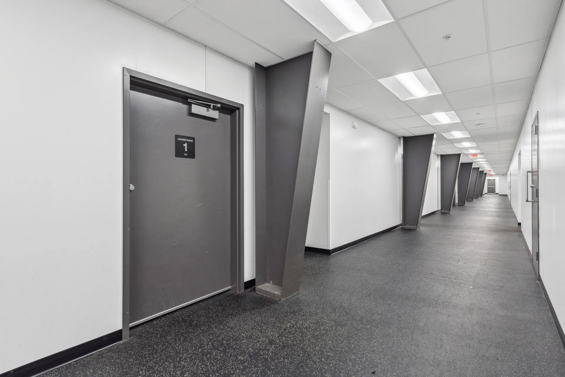 A long hallway with the entry way to the locker rooms.