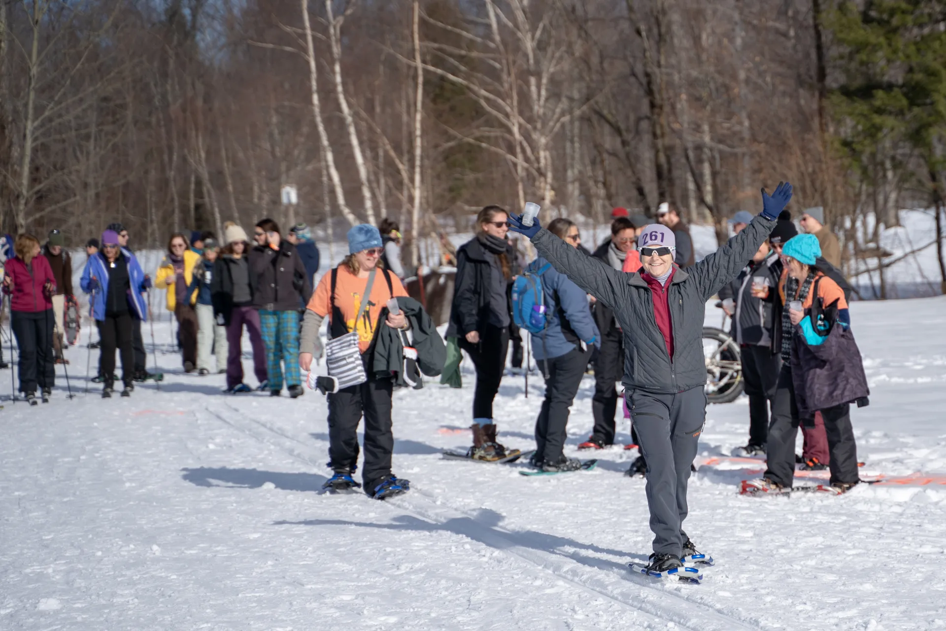 Snowshoers and cross-country skiers on a trail. 