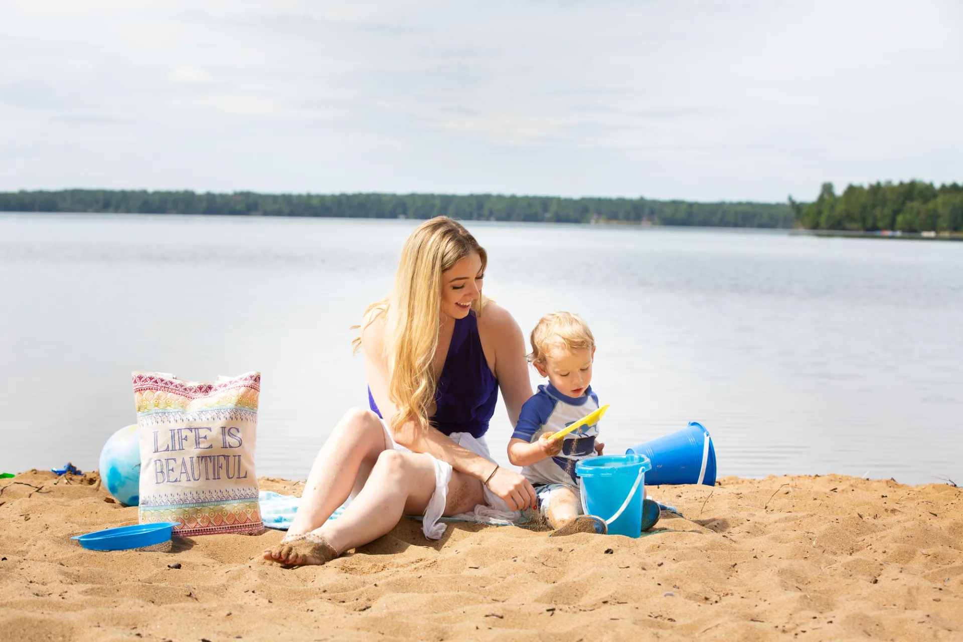 A mother and her child playing on a beach