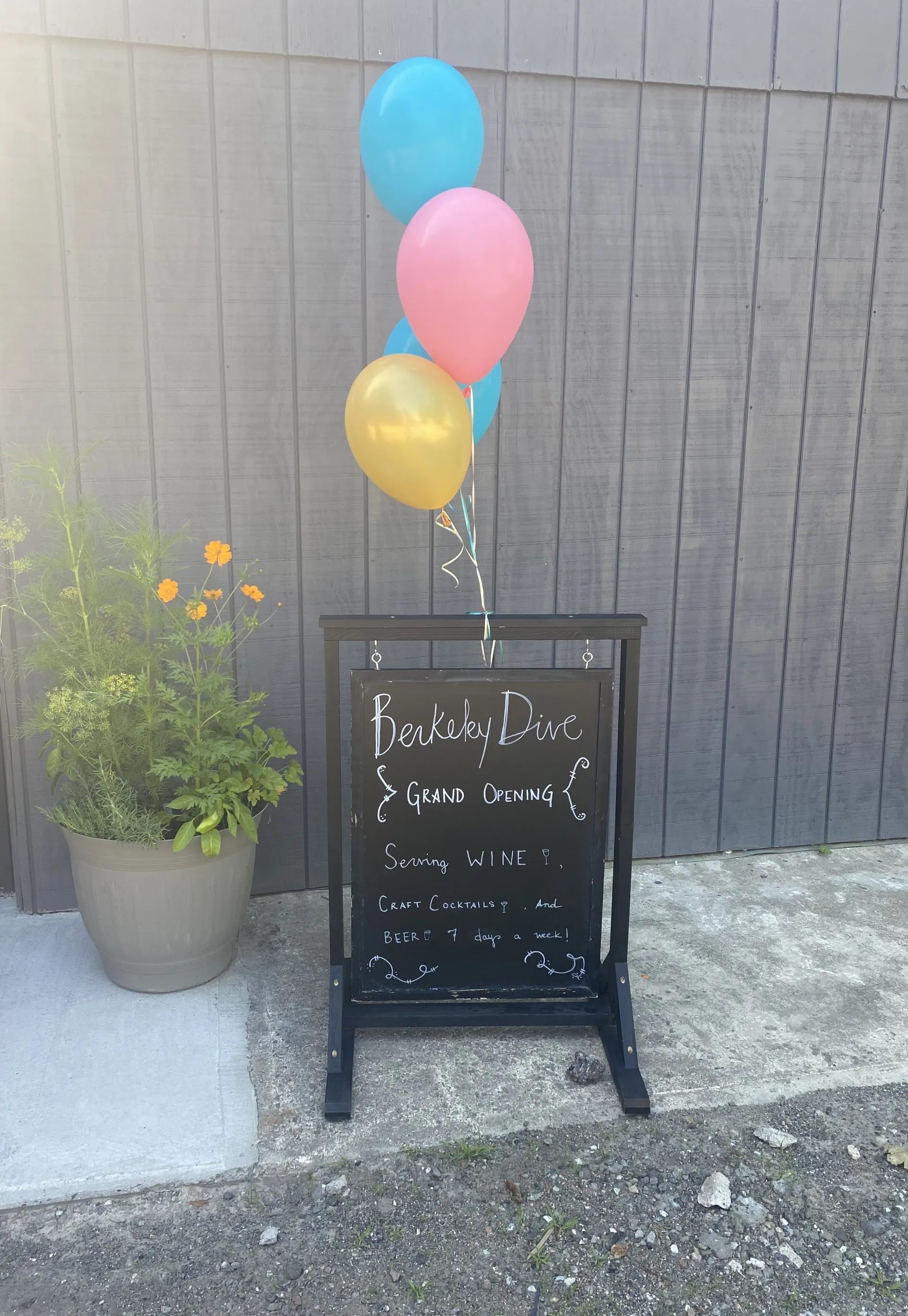 Grand opening sign with colorful balloons