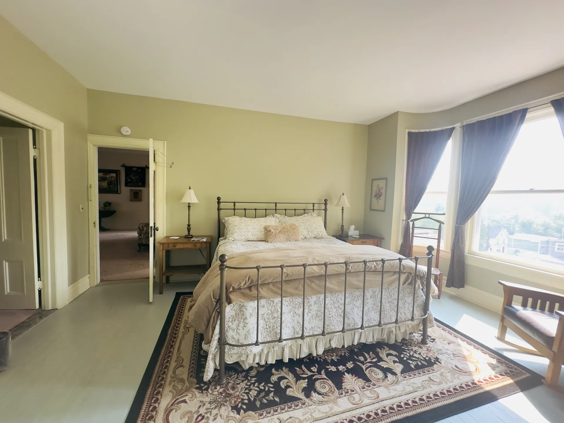 Huge bay windows flood this bedroom with light.