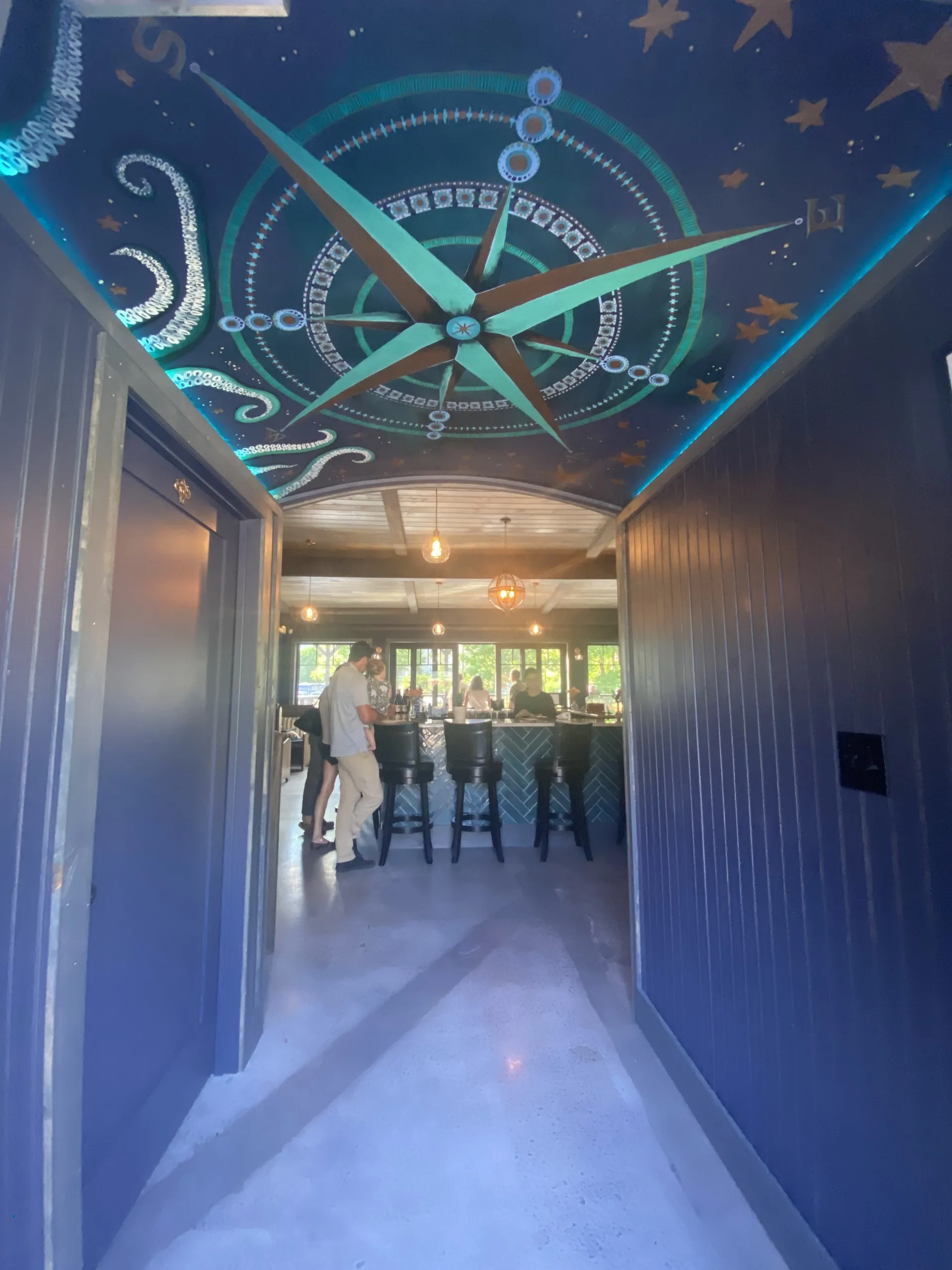Entry way with ceiling mural of a cardinal directions compass