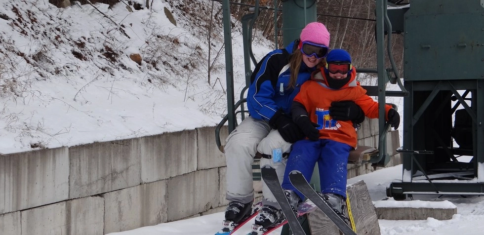 A couple kids on the ski lift at Titus Mountain.