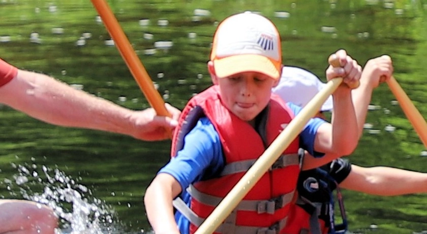 A young paddler is very focused on his technique