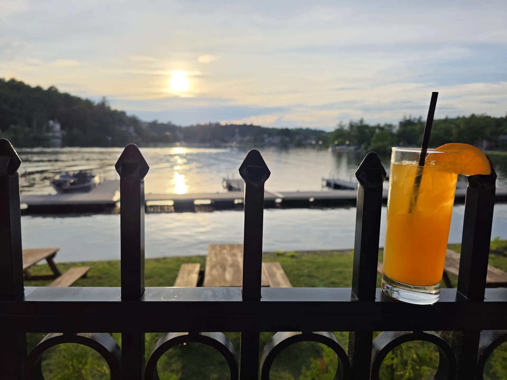 A sunset view of the lake from the patio with a freshly poured beverage