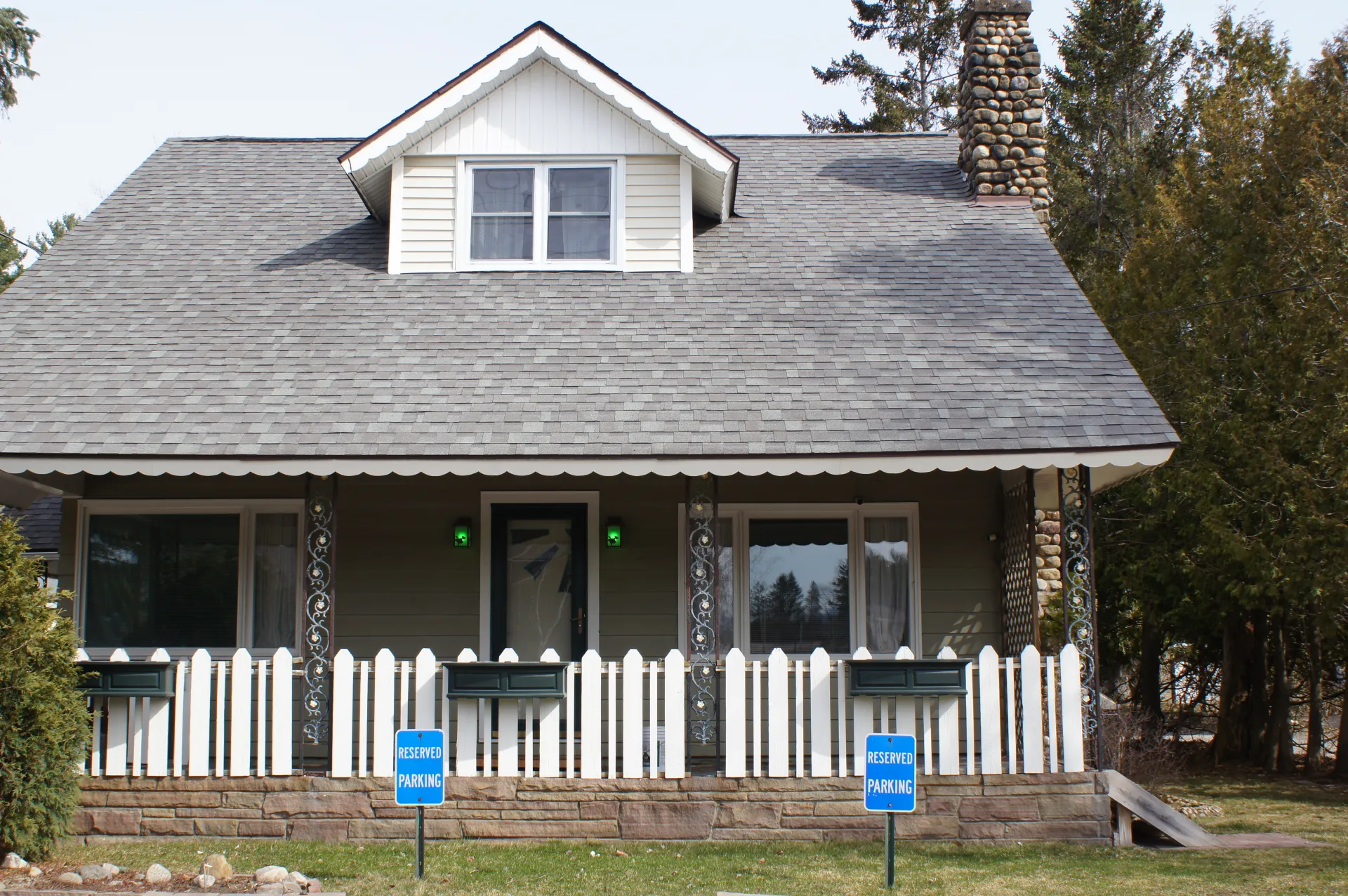 The house from the front with white picket fence at The Ashley.