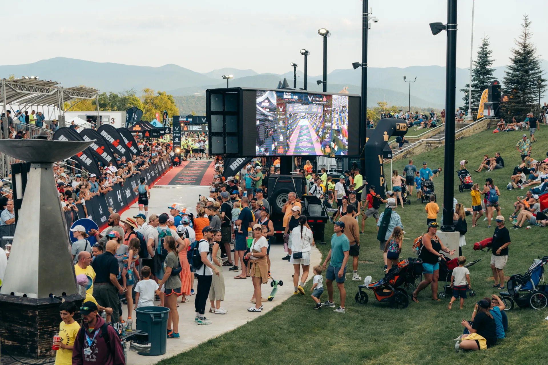 Ironman spectators at finish watching jumbotron