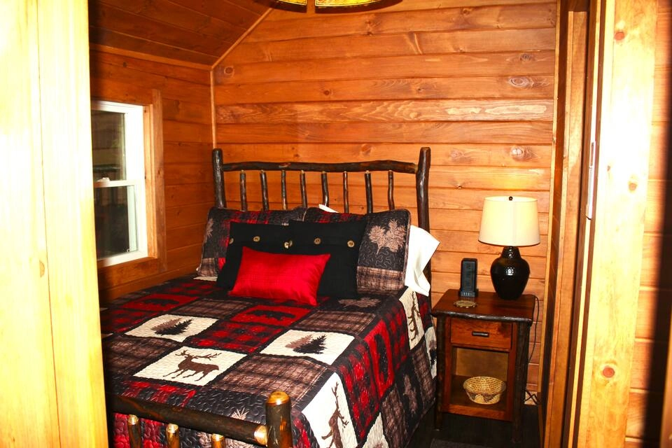 Rustic bedding in the cozy sleeping space at Rockledge Cabins & Retreats 