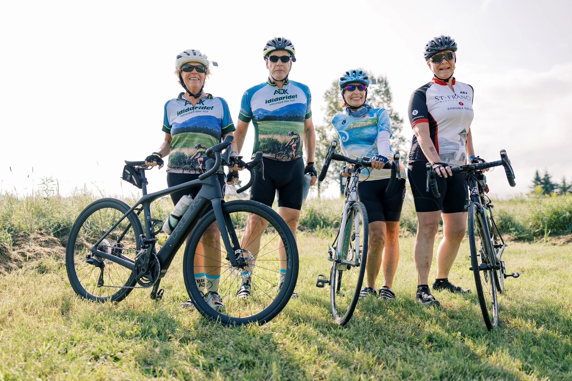 4 smiling people on bikes 