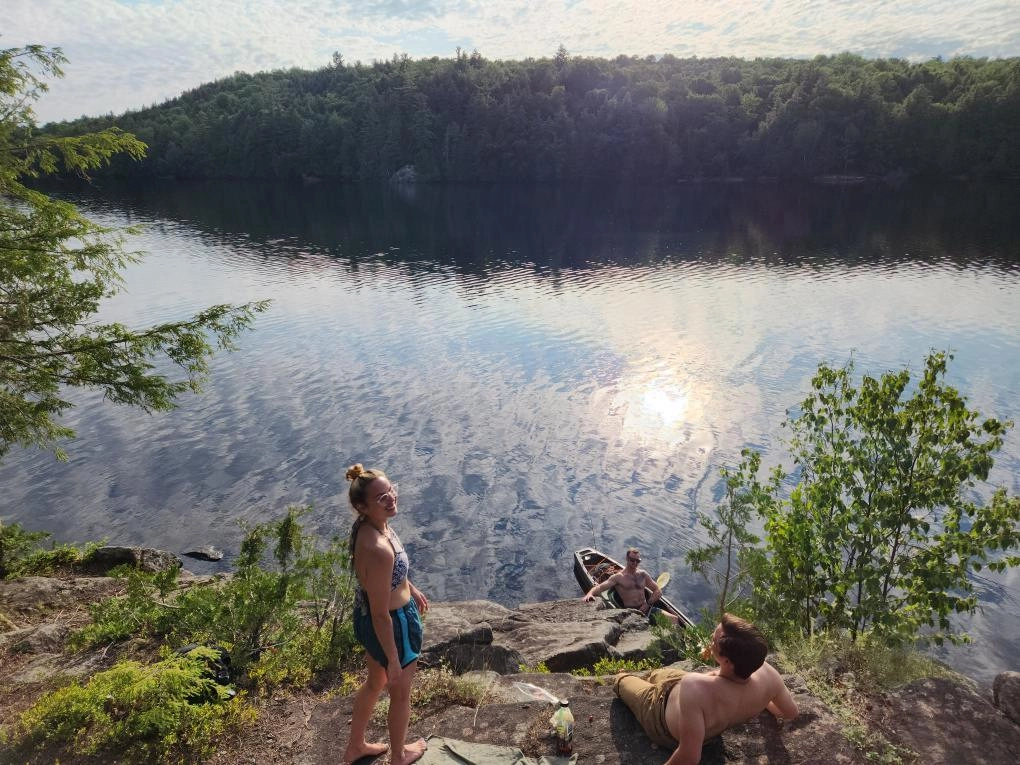 Swimmers on the shore of Moose Pond.