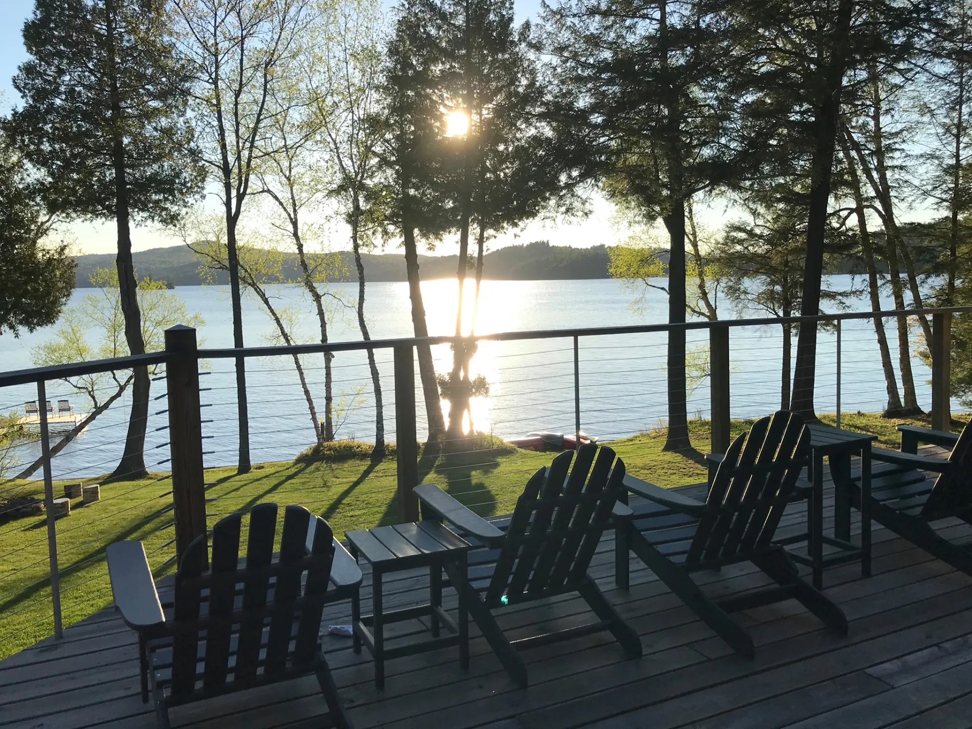 A view of the lake from the deck overlooking the expansive lawn at Alpenglow Lakeside Lodge.