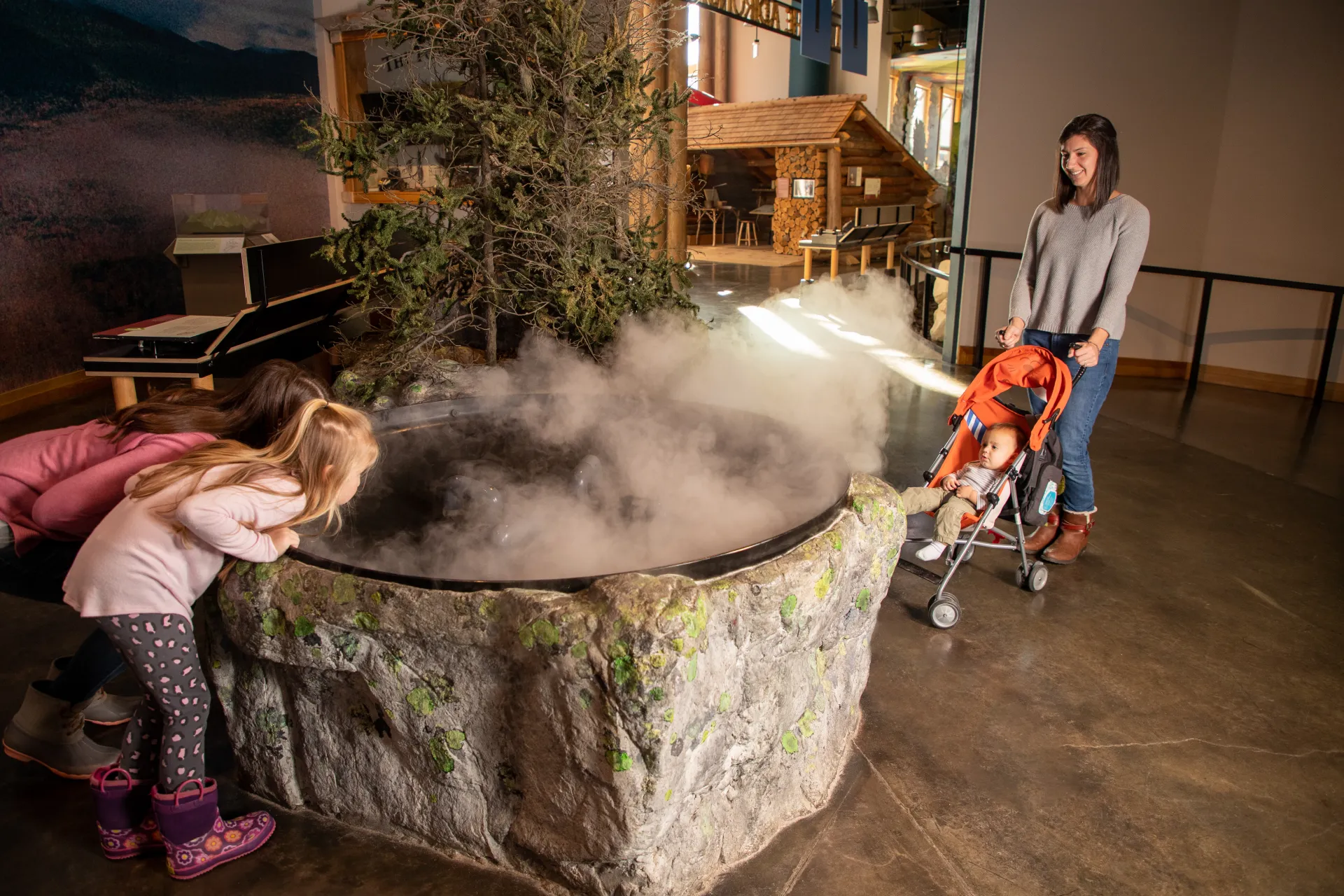 A family explores a foggy exhibit at Tupper Lake's Wild Center