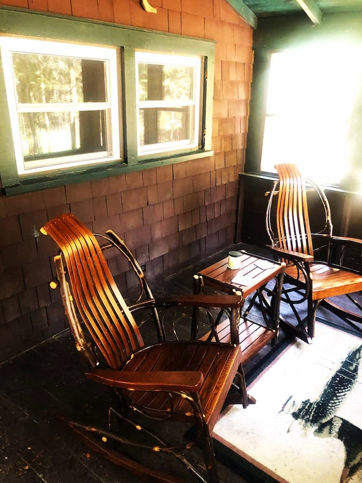 Wooden rocking chairs on the front porch at Rockledge Cabins & Retreats 