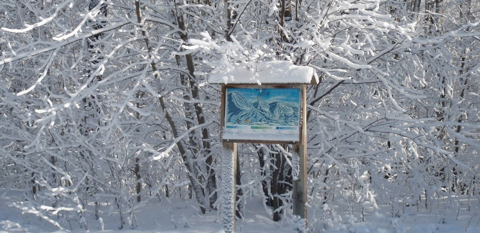 A trail sign on the trails at Titus Mountain.