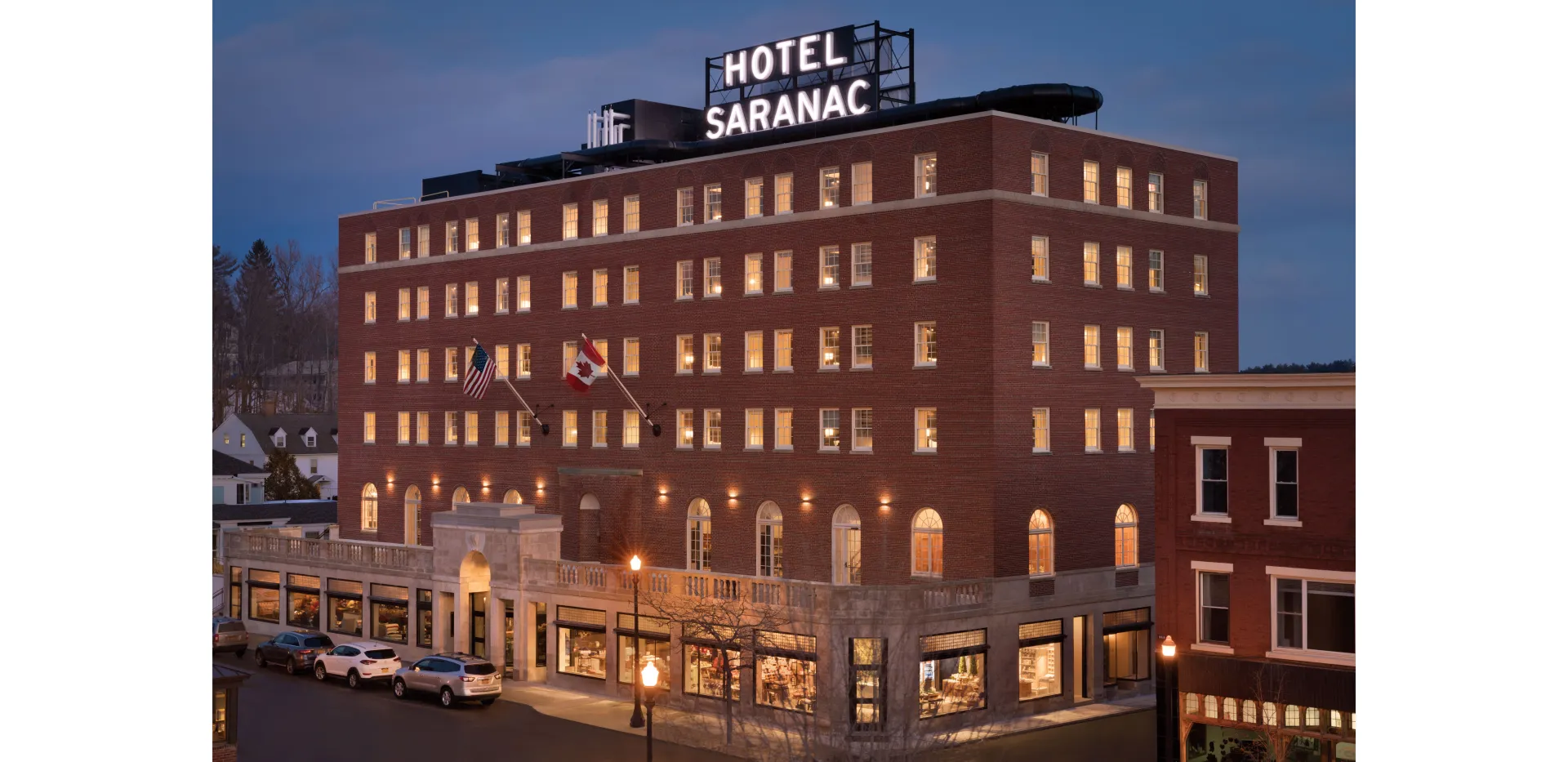 Aerial view of the Hotel Saranac lit up at dusk
