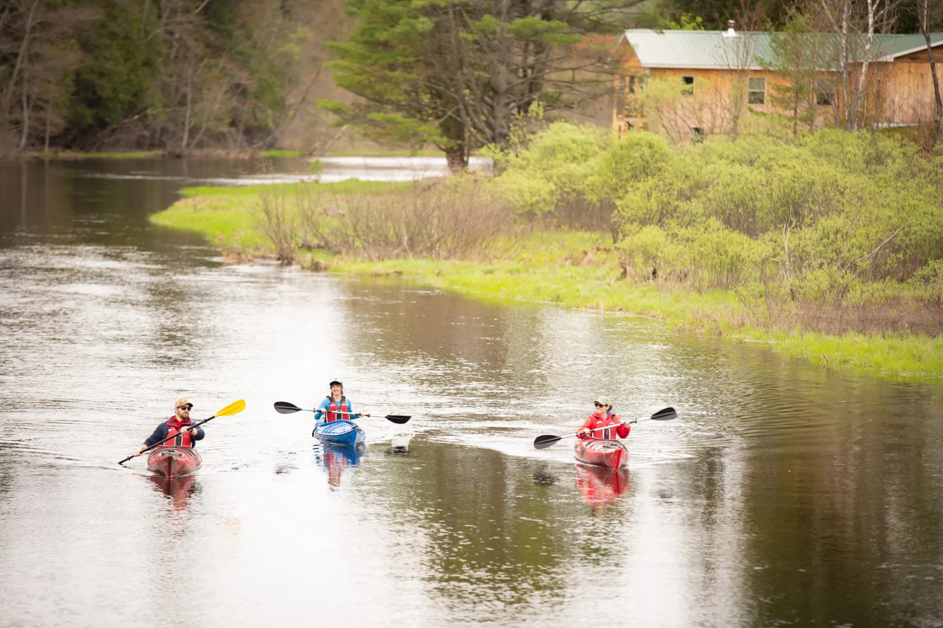 Three paddlers in the Saranac River