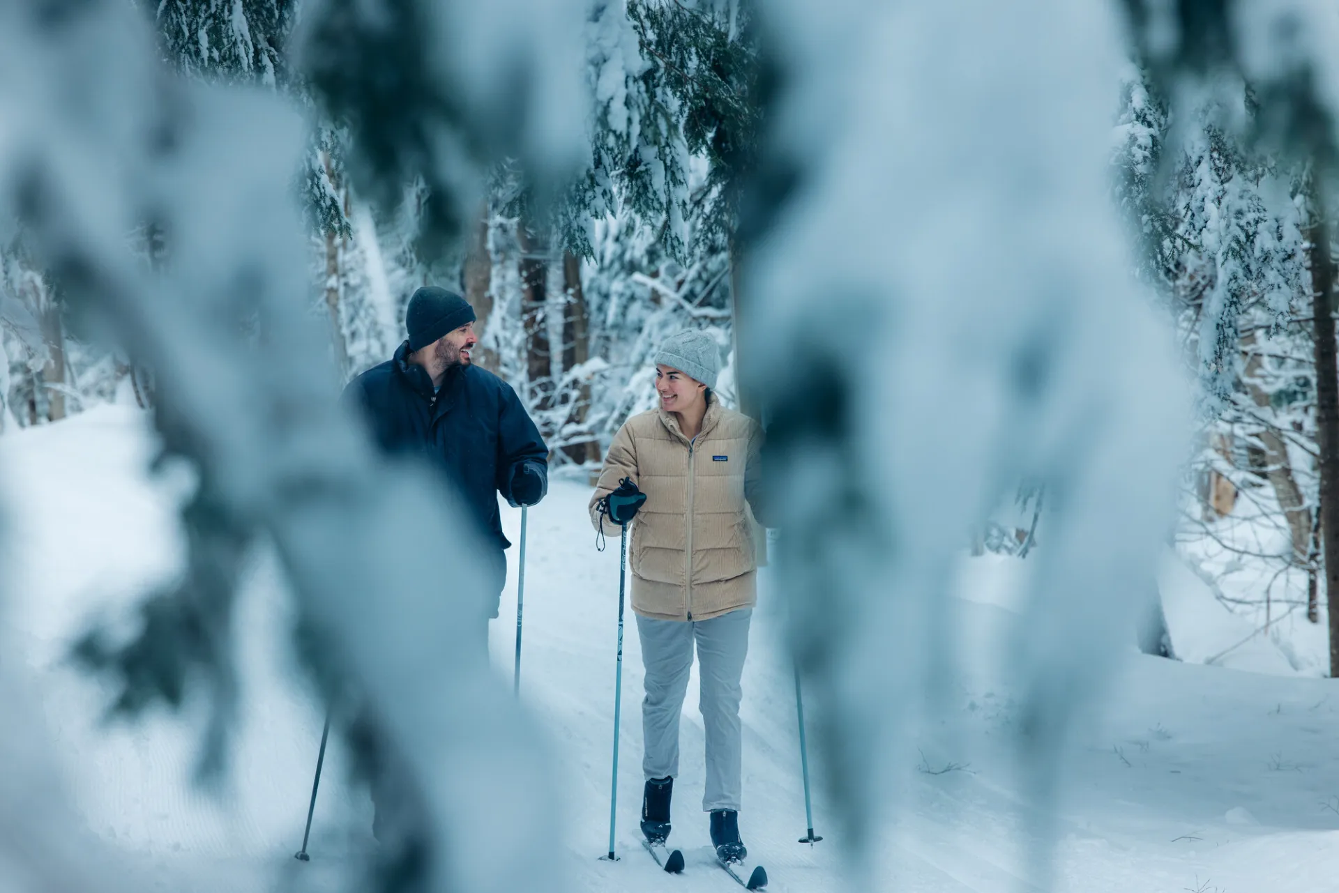 A couple cross-country skiing in Saranac Lake.