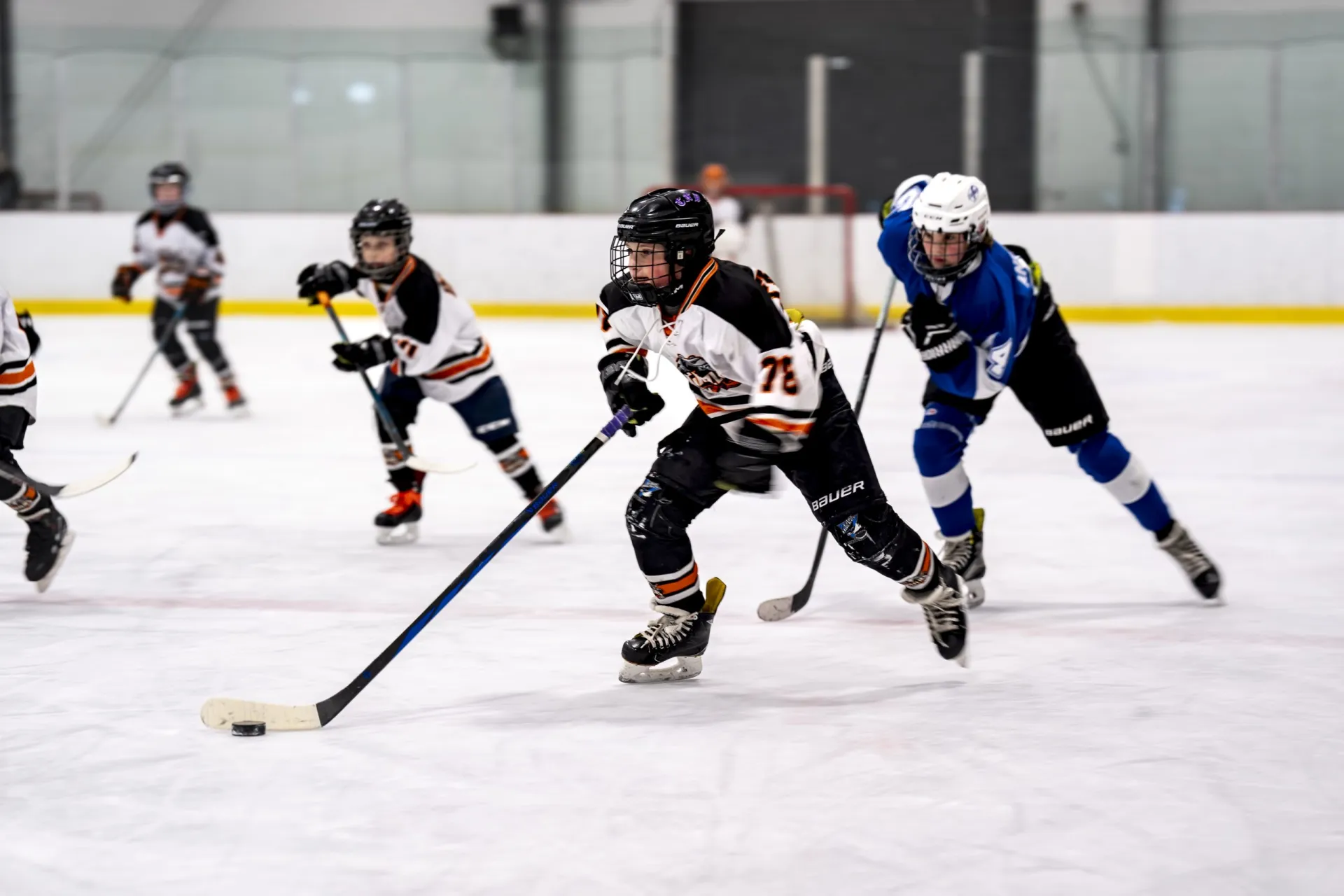 Youth hockey players in action on the ice, showcasing teamwork and skill.