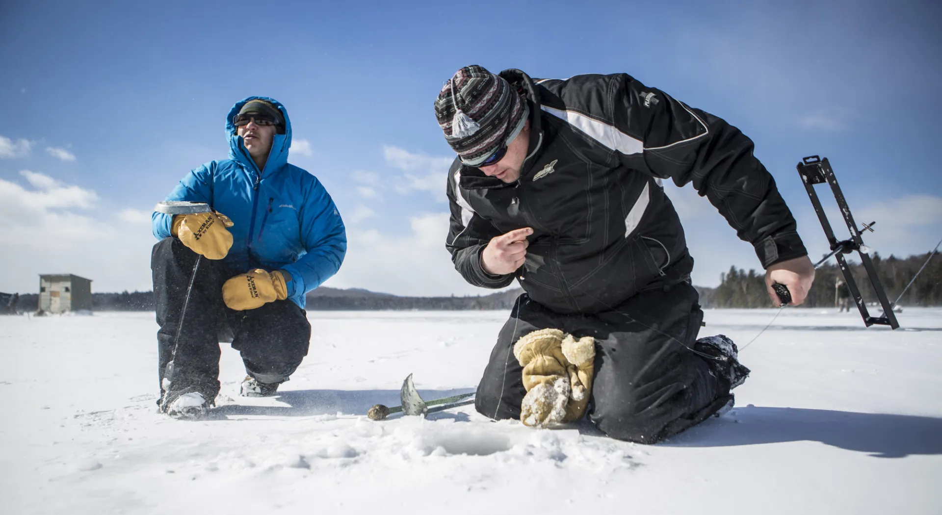 Two men ice fishing on Lake Colby