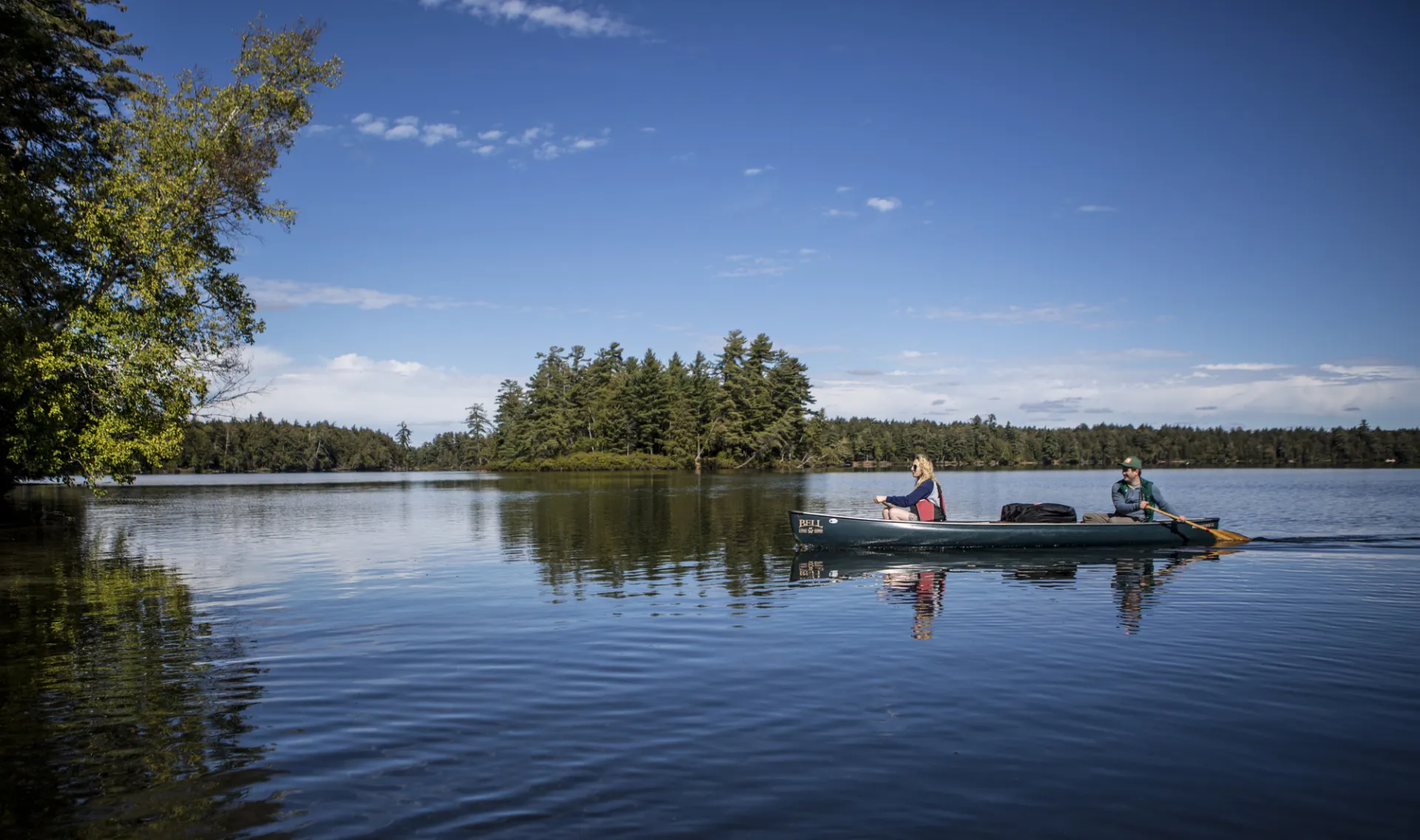 Two paddlers in a canoe on calm waters