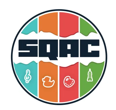 SQAC in badge striped  blue, orange, red and green with the symbols of a G cleft, rubber duck, artist pallet with clock tower