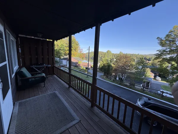 The expansive view of Saranac Lake, Lake Flower and the surrounding mountains from the deck on Mini-Malbec Lodge