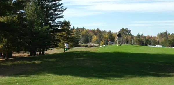 Two golfers walk the course.