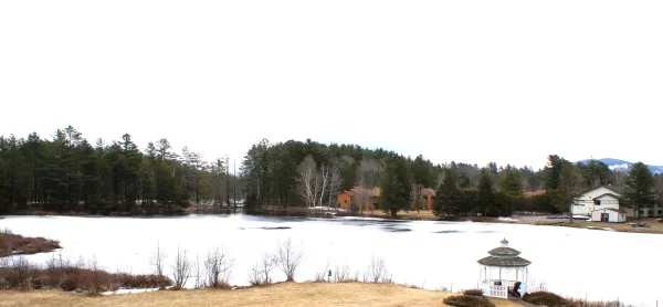The snow covered pond by Sara Placid Inn & Suites.