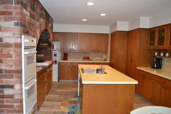 A large kitchen with brick arch