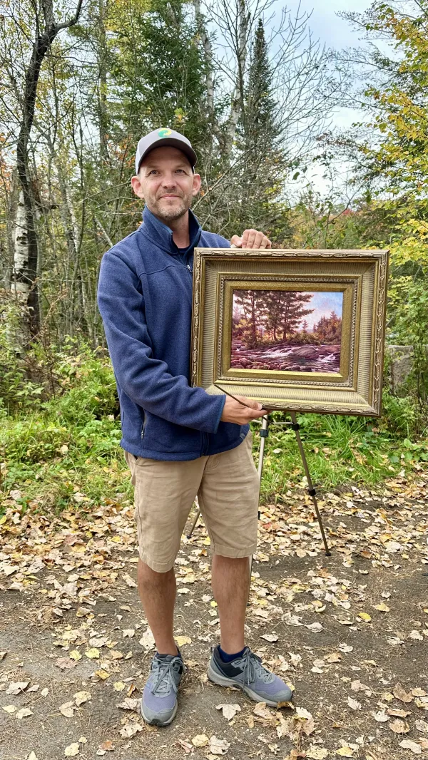 artist holding frame