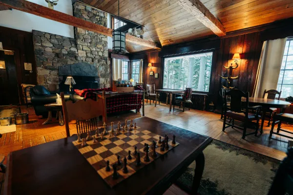 A grand lodge bedroom with a chess board and wood finishings.