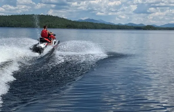 A jet skier rides through the water.