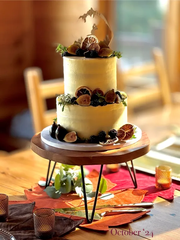 A two tiered cake decorated with dried fruits.