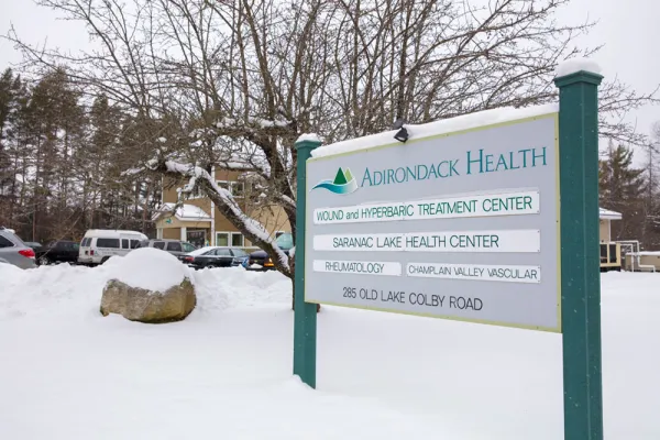 Entry sign with doctor names at the front of the Saranac Lake Health Center