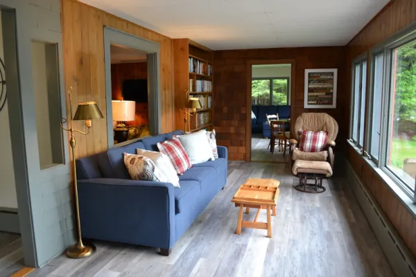 A cozy living room with couch and rocking chair