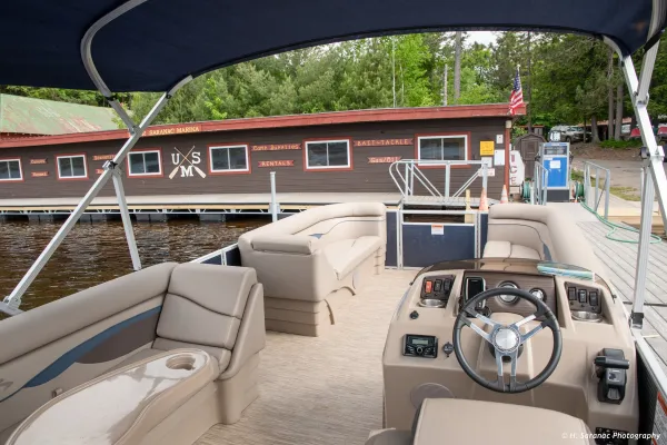 inside view of pontoon boat rental with marina rental cabin in the background