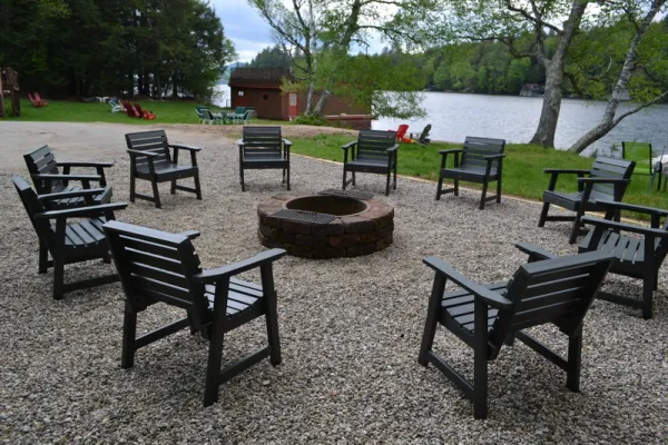 Plenty of seating surrounding a fire pit on a gravel patio
