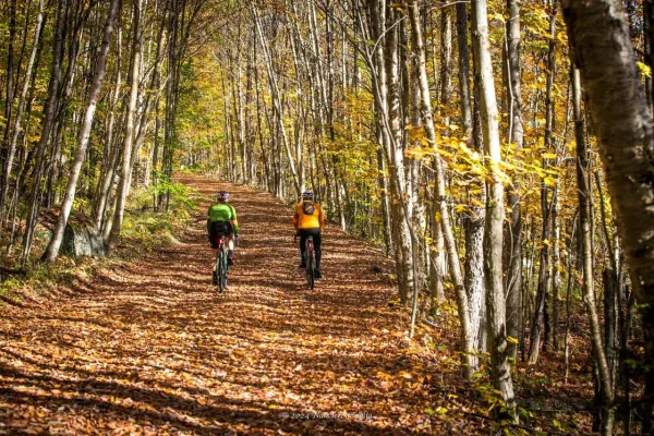 two cyclists on a backcountry trail on a sunny fall day 